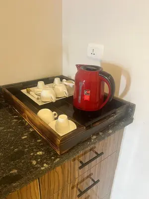 a red tea kettle on a tray on a counter at La Blanca in Hurghada