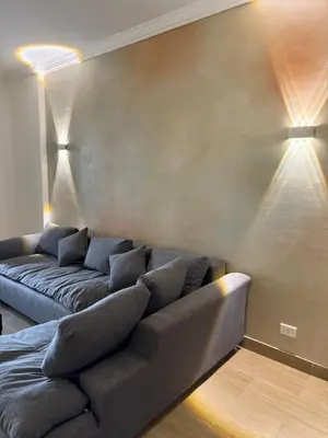 a living room with a couch and two lights at Red Sea Horizon in Hurghada