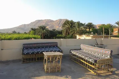 three chairs and a table on top of a patio at Tohamy house in Al Aqālitah