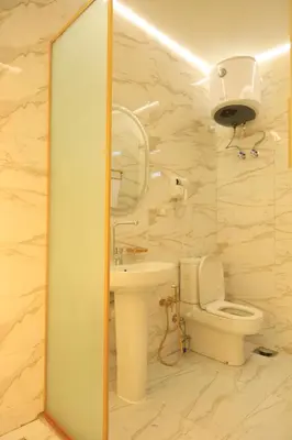 a bathroom with a white toilet and a sink at Crystala 2 guest house in Aswan