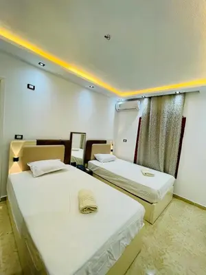 a room with two beds and a window at Modern place Hurghada in Hurghada