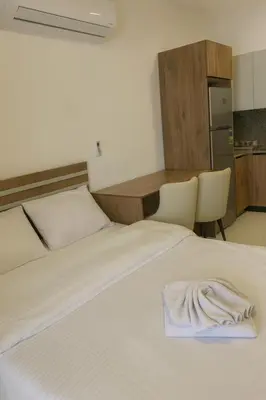 a white bed with a towel on top of it at Hurghada concierge at La Prestigia B2 4 in Hurghada