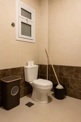a bathroom with a toilet and a trash can at Hurghada concierge at La Prestigia B2 4 in Hurghada