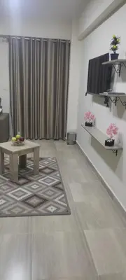 a living room with a table and a television at Princess resort217 in Hurghada