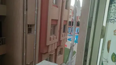 a reflection of a building in a glass window at Elite House in Hurghada