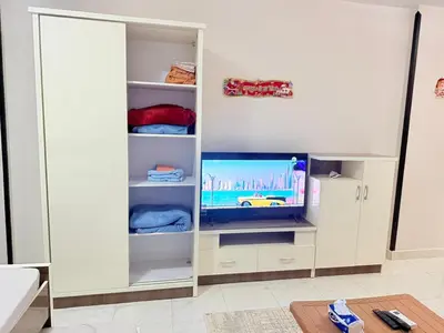 a white closet with a tv in it at Al Mutamayz Tiba in Hurghada