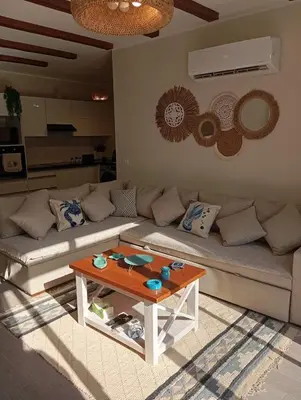 a living room with a couch and a table at Bali 2 bed with private pool in Hurghada