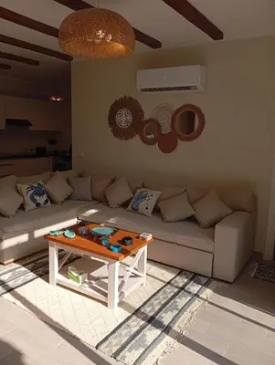 a living room with a couch and a table at Bali 2 bed with private pool in Hurghada