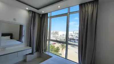 a bedroom with a large window with a view at Stylish Sunny Central 1BR in Hurghada