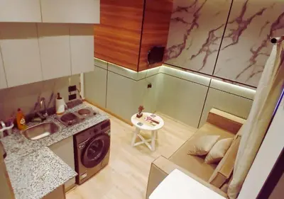 a small kitchen with a sink and a stove at Modern Sea View Palma House Steps from Dream Beach in Hurghada