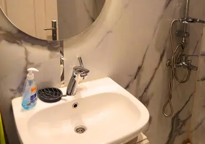 a white sink in a bathroom with a mirror at Modern Sea View Palma House Steps from Dream Beach in Hurghada