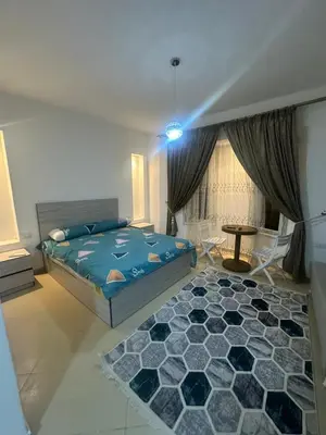 a bedroom with a blue bed and a rug at Balkan Resort in Hurghada