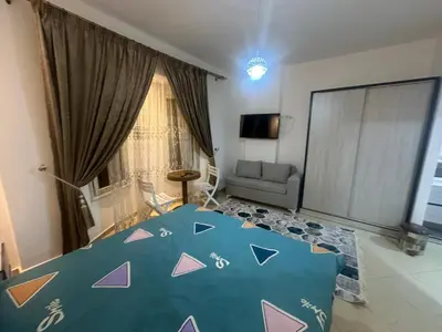 a bedroom with a large blue bed with a design on it at Balkan Resort in Hurghada