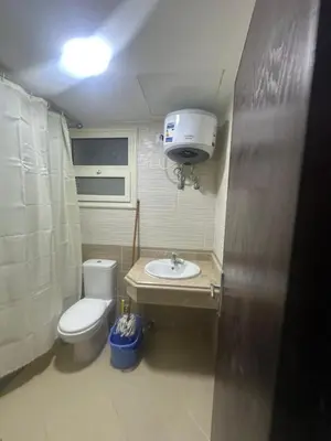 a small bathroom with a toilet and a sink at Balkan Resort in Hurghada