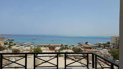 a view of a beach and the ocean from a balcony at Sea view 3 bedrooms apartment 06 in Hurghada