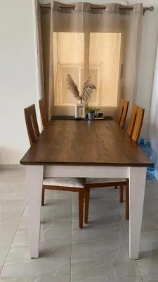 a dining room table with chairs and a wooden table with at Sea view 3 bedrooms apartment 06 in Hurghada
