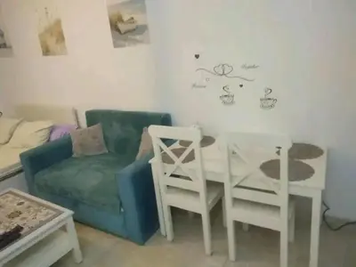 a living room with a couch and a table and chairs at Sheraton Plaza in Hurghada