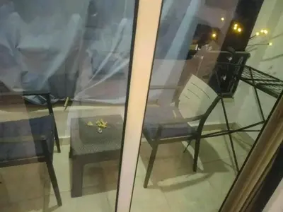 a reflection of a chair and a table in a window at Sheraton Plaza in Hurghada