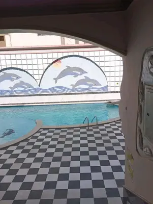 a view of a swimming pool from a room with a checkered floor at Sheraton Plaza in Hurghada