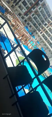 a view of a table with chairs and a pool at جولدن طيبه الذهبيه in Hurghada