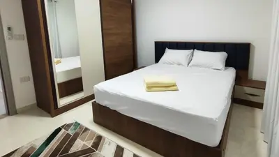 a bedroom with a large bed with a mirror at Comfort quiet central new flat in Hurghada