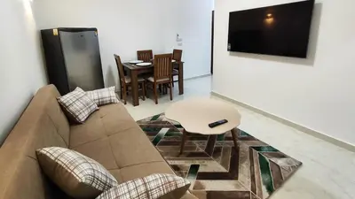 a living room with a couch and a table at Comfort quiet central new flat in Hurghada