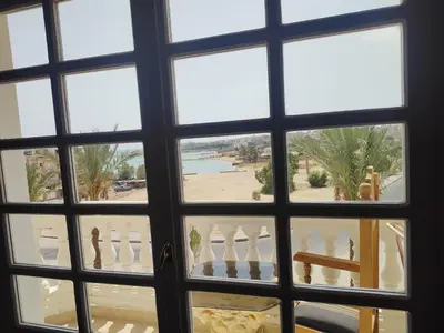 a window view of a beach from a house at Antique apartment with sea view in Hurghada