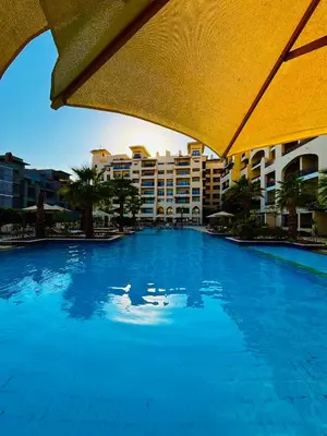 a large swimming pool in front of a hotel at Prime Square Aldau Heights in Hurghada
