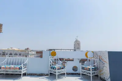 a pair of chairs on the roof of a building at Sultan's Suite-Chill Out Roof Terrace-3 Bedrooms in Hurghada