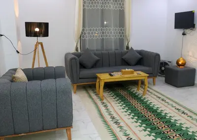 a living room with two couches and a coffee table at Sultan's Suite-Chill Out Roof Terrace-3 Bedrooms in Hurghada