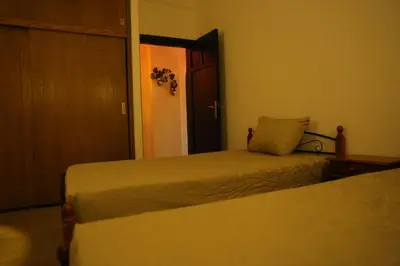 a bedroom with two beds and an open door at Casa Hurghada in Hurghada