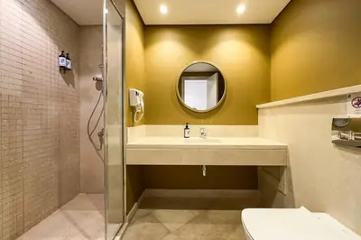 a bathroom with a sink and a mirror at The Golden Atrium 3BDR Pool View Free Pool & Beach Access in Hurghada