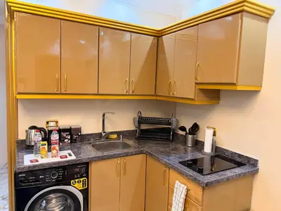 a kitchen with a sink and a washing machine at Oscar Apartment 9 in Luxor