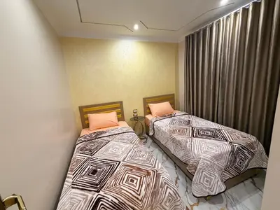 two beds sitting next to each other in a bedroom at Oscar Apartment 9 in Luxor