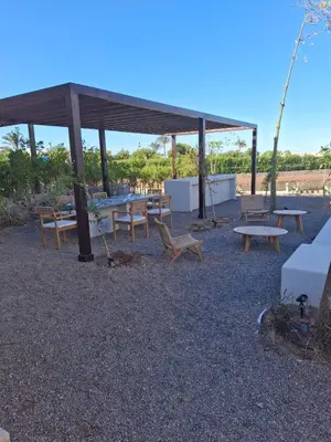 a group of picnic tables and benches under a pavilion at Gouna 3 bedrooms townhouse cyan in Hurghada