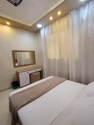 a bedroom with two beds and a television at Hurghada - star beach water front chalets - 3BR in Hurghada