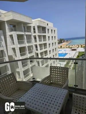 a table and chairs on the balcony of a building at Scandic in Hurghada