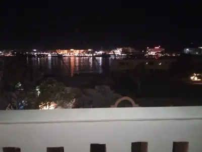 a view of the water at night from a balcony at The Horizon House in Luxor