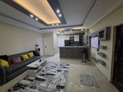a living room with a couch and a kitchen at Luxury family apartment in Hurghada in Hurghada