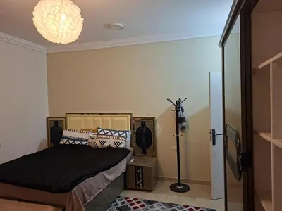 a bedroom with a bed and a lamp in it at Luxury family apartment in Hurghada in Hurghada