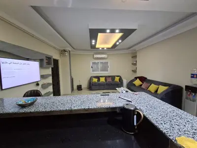 a conference room with a table and a projection screen at Luxury family apartment in Hurghada in Hurghada