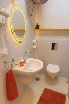 a bathroom with a sink and a toilet and a mirror at Oscar Apartment 8 in Luxor