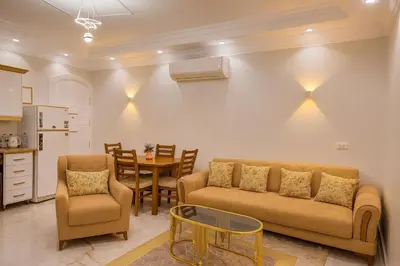 a living room with a couch and a table at Oscar Apartment 8 in Luxor