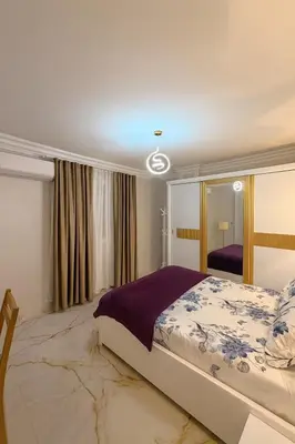 a bedroom with a bed and a large mirror at Oscar Apartment 8 in Luxor