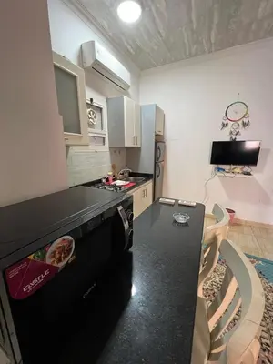 a kitchen with a black counter top in a room at one bedroom at magawish hurghada in Hurghada