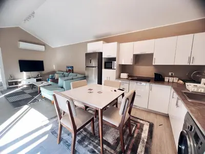 a kitchen and living room with a table and chairs at Two Bedroom with Private pool in Hurghada