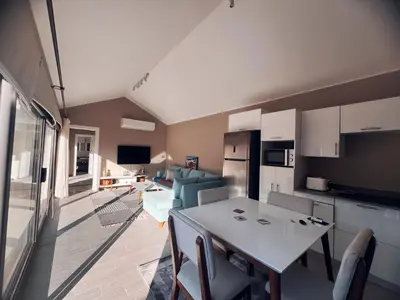 a kitchen and living room with a table and chairs at Two Bedroom with Private pool in Hurghada