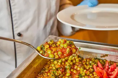 a spoonful of food on top of a tray of food at Juliana Golden Beach Resort in Hurghada