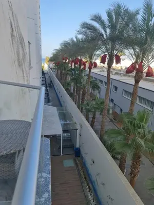 a balcony with palm trees on the side of a building at Happy Home Hurghada in Hurghada
