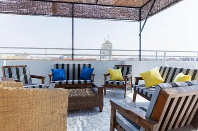 a group of chairs sitting on top of a building at Spacious and Chic 3 Bedroom Appartment Beautiful Rooftop Terrace Great location to explore Hurghada in Hurghada